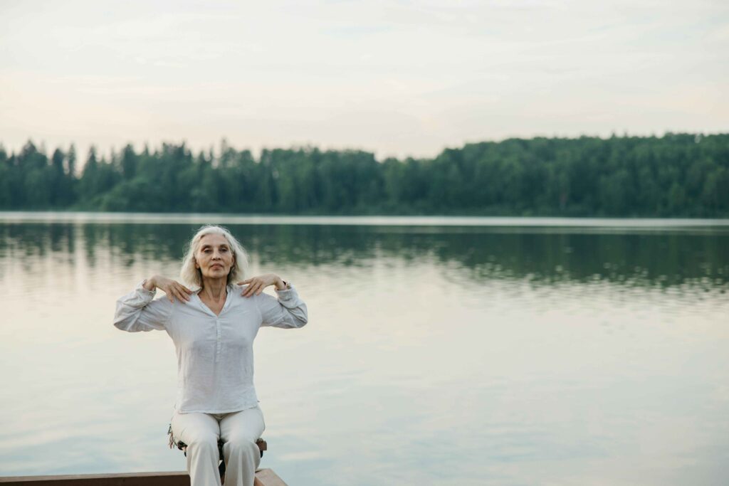 Widow practicing self-care through meditation and mindfulness during grief recovery